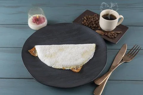 Melted mozzarella cheese tapioca, next to a cup of black coffee blue wood b.. Stock Photos