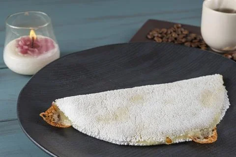 Melted mozzarella cheese tapioca, next to a cup of black coffee blue wood b.. Stock Photos