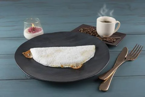 Melted mozzarella cheese tapioca, next to a cup of black coffee blue wood b.. Stock Photos