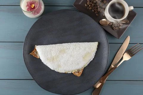 Melted mozzarella cheese tapioca, next to a cup of black coffee blue wood b.. Stock Photos
