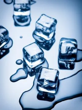 Melted pieces of ice on a dark background Stock Photos