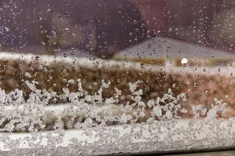 Melted snow forms droplets above, packed snow below Stock Photos