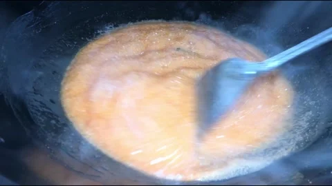 Melted sugar boils in a pan over medium heat stove Stock Footage 244637531