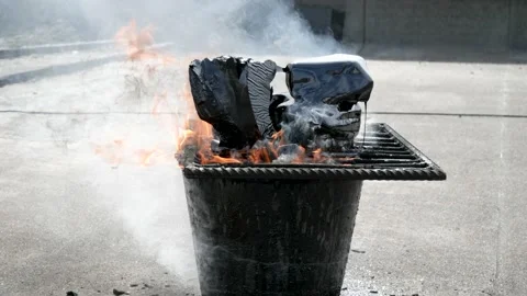 Melting bitumen on the grid in the bucket by fire for a roof repair Stock-Footage 131486051