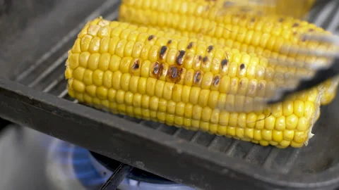 Melting butter on hot corn, corn on the cob with butter  on the grill plate, Stock Footage 148329243