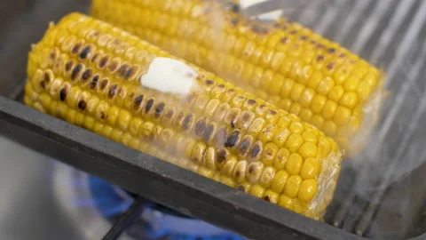 Melting butter on hot corn, corn on the cob with butter  on the grill plate, Stock Footage 148329591