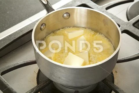 Melting Butter in a Pot on the Stove Stock Photos
