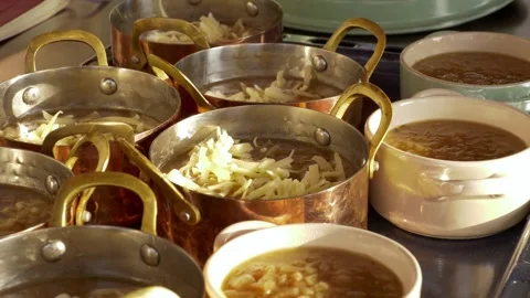 Melting cheese in a soup, copper kitchenware Stockbeeldmateriaal 318105237