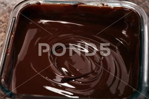 Melting chocolate, melted delicious chocolate for praline icing confectionery Stock Photos