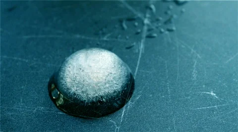 Melting Circular Ice Cube Stock Footage 611073