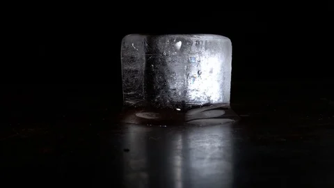 Melting Clear Ice Cube on Black Background - Time Lapse Stock Footage 126939503