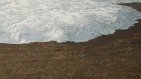 Melting glacier ice meets dry land in a remote area Stock-Footage 344552585