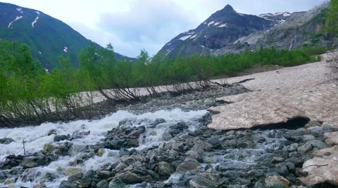 Melting of the glacier. Mountain Stream flowing Under Ice Vídeo Stock 65574742