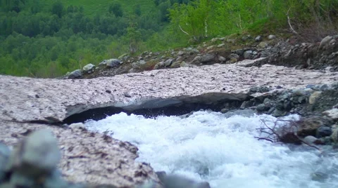 Melting of the glacier. Mountain Stream flowing Under Ice Vídeos de archivo 65578140