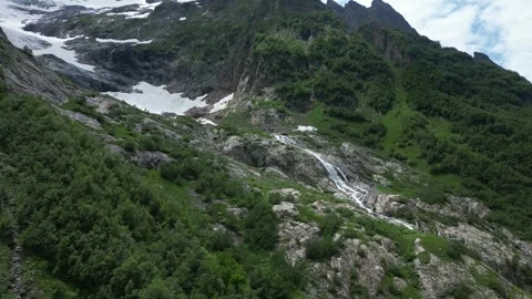 Melting glacier in the mountains in spring view of waterfall Stock Footage 307878480