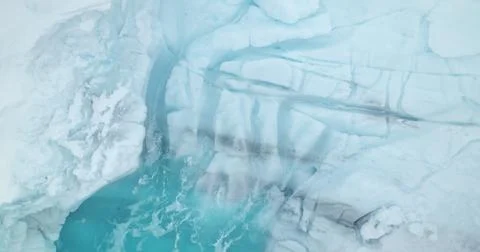 Melting glacier pattern deep crack turquoise water Stock Photos