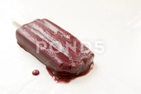 Melting grape popsicle Stock Photos