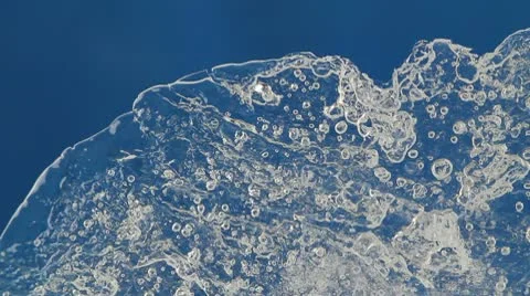 Melting ice closeup on blue background. accelerated shoot Stock Footage