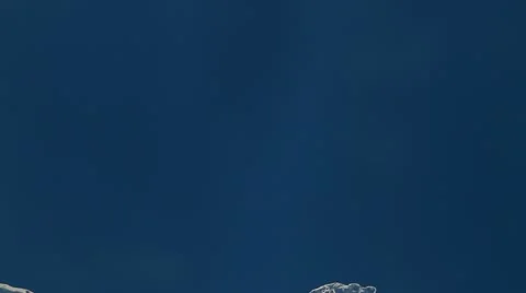 Melting ice closeup on blue background. accelerated shoot. reverse Stock Footage 10574953