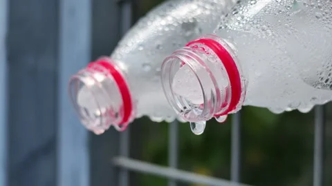 Melting Ice on Cold Water Bottles in Slow Motion Stock Footage 340828265