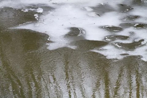 Melting ice covers the spring river Stock Photos