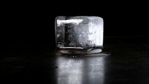 Melting Ice Cube Isolated on Black Background Stock Footage 122250307