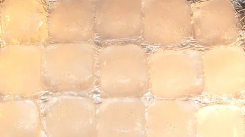 Melting ice cubes orange 28sec, 4k Stock Footage 80051499