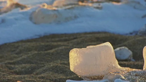 Melting Ice Cubes in Warm Sunset Light on Ground Stock Footage 326371741
