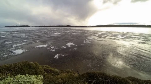 Melting ice floating at lake in spring time-lapse Stock Footage 75565689