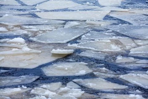 Melting ice. Icebergs in the water. Floating ice floes in blue cold water. Stock Photos