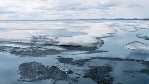 Melting ice on the lake. The structure of spring ice. The concept of nature. Stock Footage 306356405