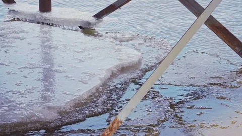 Melting ice on the river between metal constructions close up Stock Footage 102345356