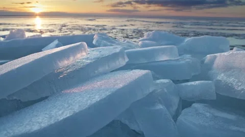 Melting ice in spring. Crashed ice in the rays of the setting sun. Blue ice on Video stock 235785602