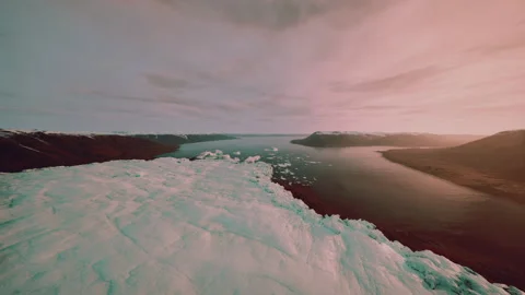 Melting ice at sunset underscores critical environmental challenges today Stockbeeldmateriaal 334336228