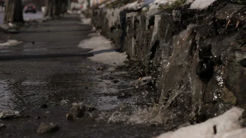 Melting Ice transforms into Water at walking road in Spring. Stock Footage 113359606