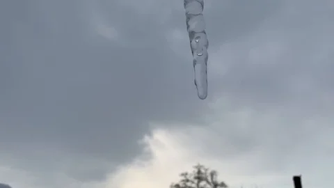 Melting icicle against the sky Stock Footage 101022380