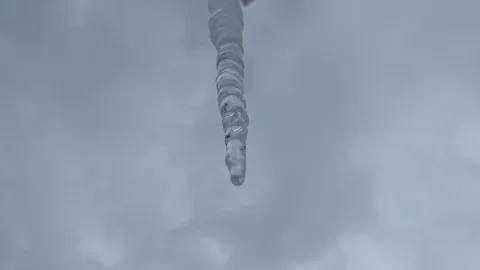 Melting icicle on a sky background Stock Footage 101022379