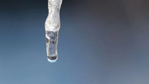 Melting icicles on a blue background. Video stock 72436374