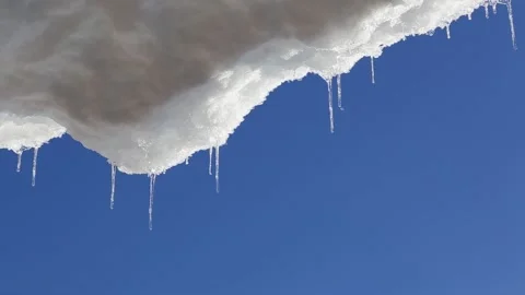 Melting icicles with the blue sky in the background Stock Footage 188978411