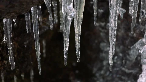 Melting icicles on a dark background. Stock Footage 171220986