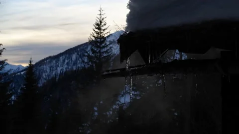 Melting icicles in front of snowy Austrian mountain panorama Stock Footage 145912205