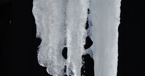 Melting icicles isolated against black background Stock Footage 264808155