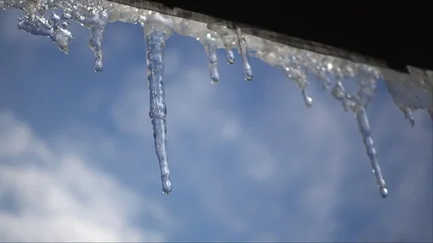 Melting icicles in the spring.  Spring warming, icicles melt under the roof. Stock Footage 84396871