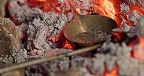 Melting metal on coals close up while making handmade things - close up. Video stock 171489652