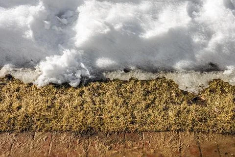 Melting snow on the side of the path Stock Photos
