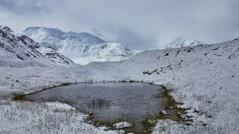Melting snow timelapse. Reflection of the sky in small mountain lake Stock Footage 70894041