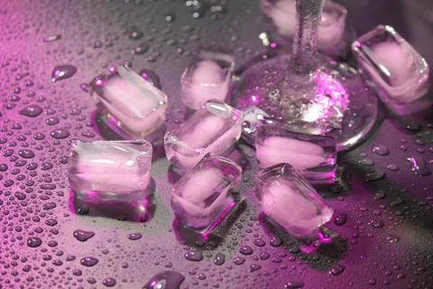 Melting transparent ice with drops of water on a dark background. Also part o Stock Photos