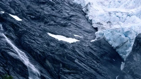 Melting water pouring down from Supphellebreen glacier in Norway Stock Footage 230177008