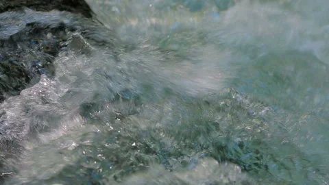 The meltwater of a mountain stream forms a foam Stock-Footage 88481668