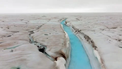 Meltwater River Flowing Through a Massive Glacier in 4k Drone Shot Stock Footage 338263668